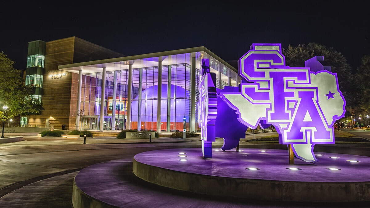 Stephen F. Austin State University STEM building lit purple at night